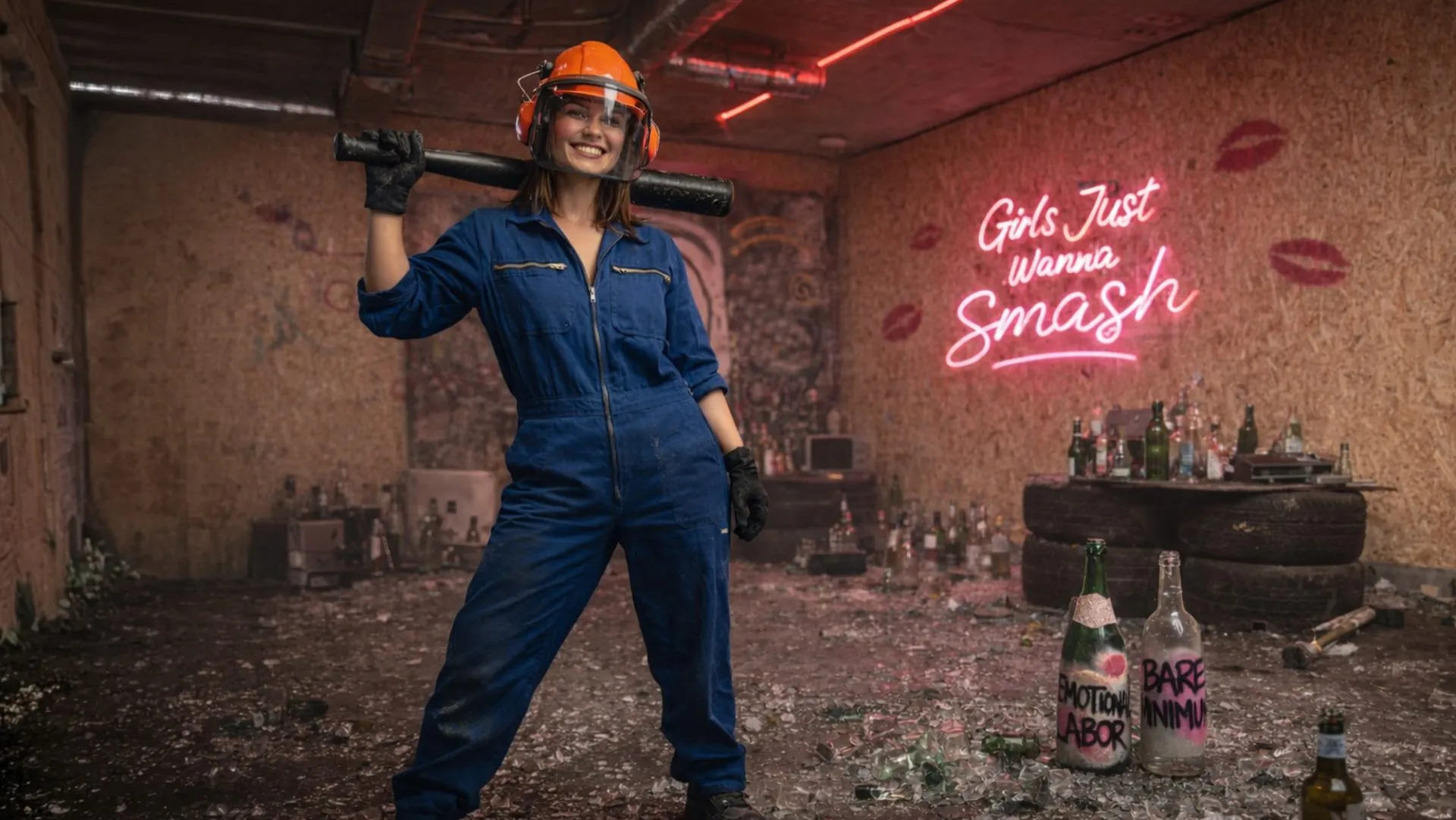 Woman in safety gear holding a sledgehammer in The Rage Room smash room